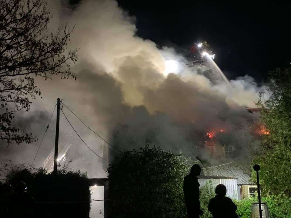 Firefighters tackle a blaze at a thatched cottage in Poxwell, Dorset