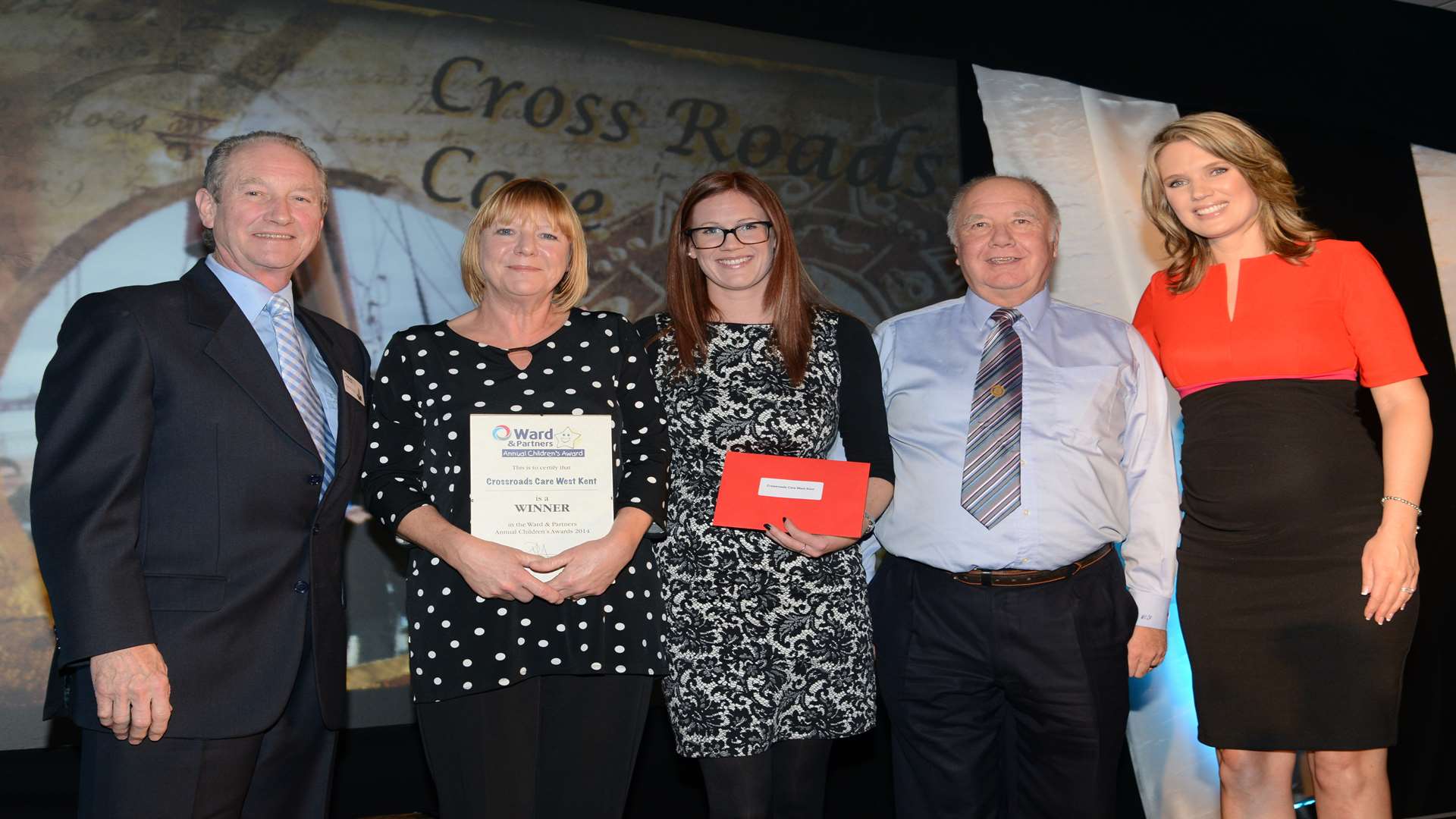 Jan Hall, Sophie Butler and Colin Trelfer collect the award for Crossroads Care