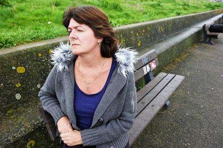 Catherine Butters sits on the memorial bench for her son Christopher Wakeman, who died after escaping from a care home