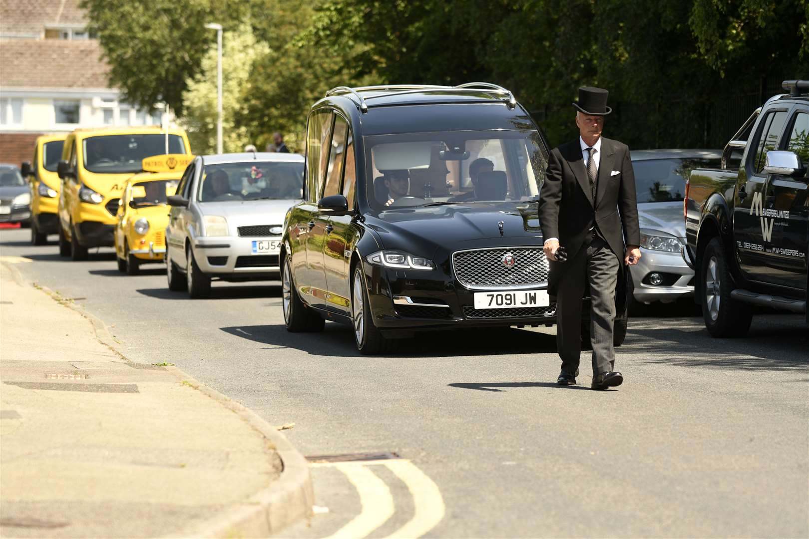The cortege is led from Silverspot Close in Rainham followed by Mr Burridge's family and the AA convoy. Picture: Barry Goodwin