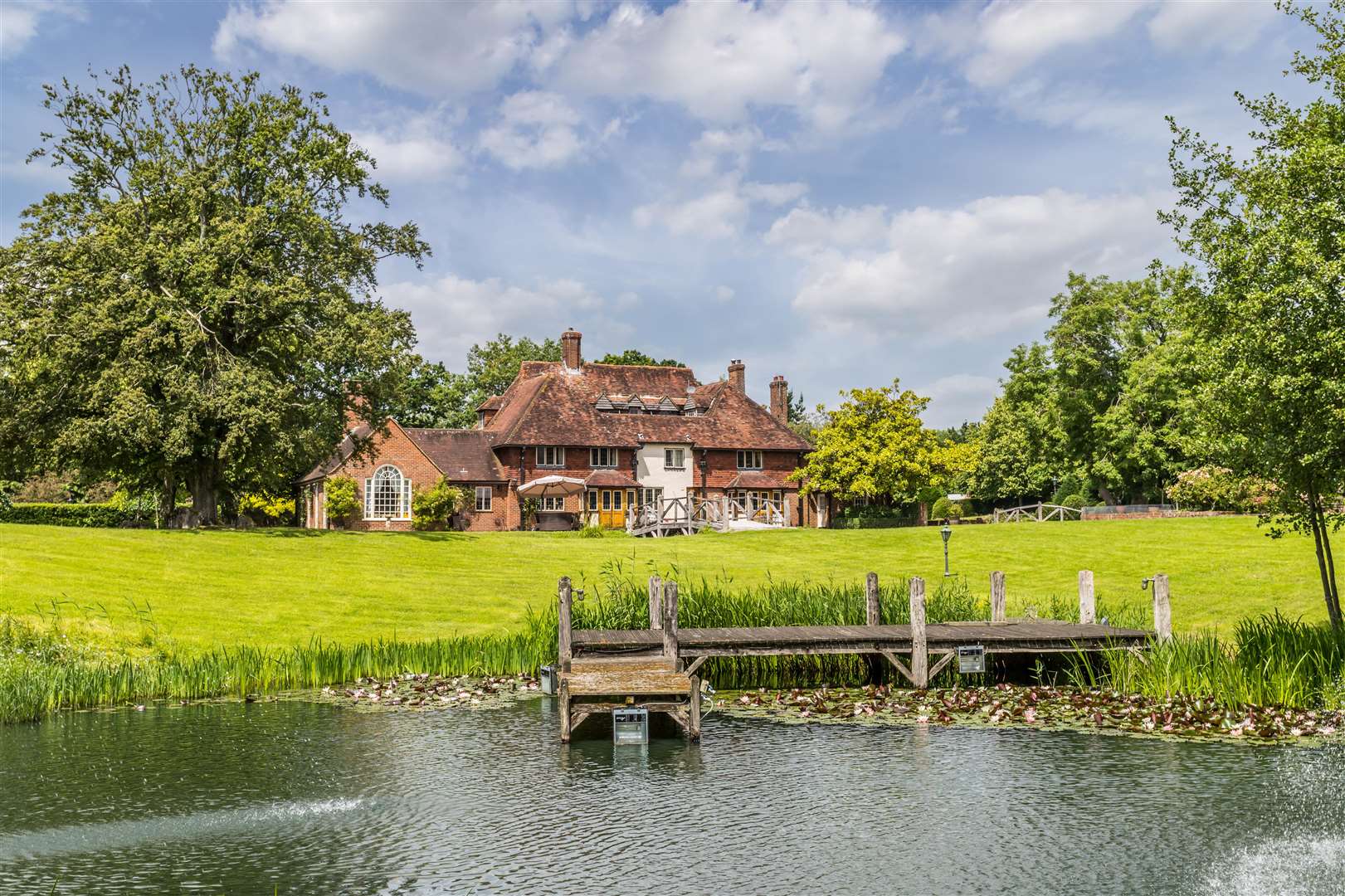 The Moat also has grounds, gardens and outbuildings Picture: Hamptons