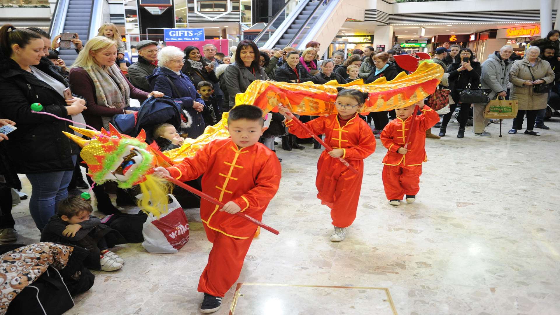Children from the Kut-O Chinese Assocation ward off evil spirits with a Dragon dance.