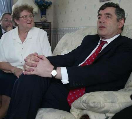HOME COMFORTS: Gordon Brown relaxes with resident Pat Rothwell on a visit to Macklands House at Rainham. Picture: PETER STILL