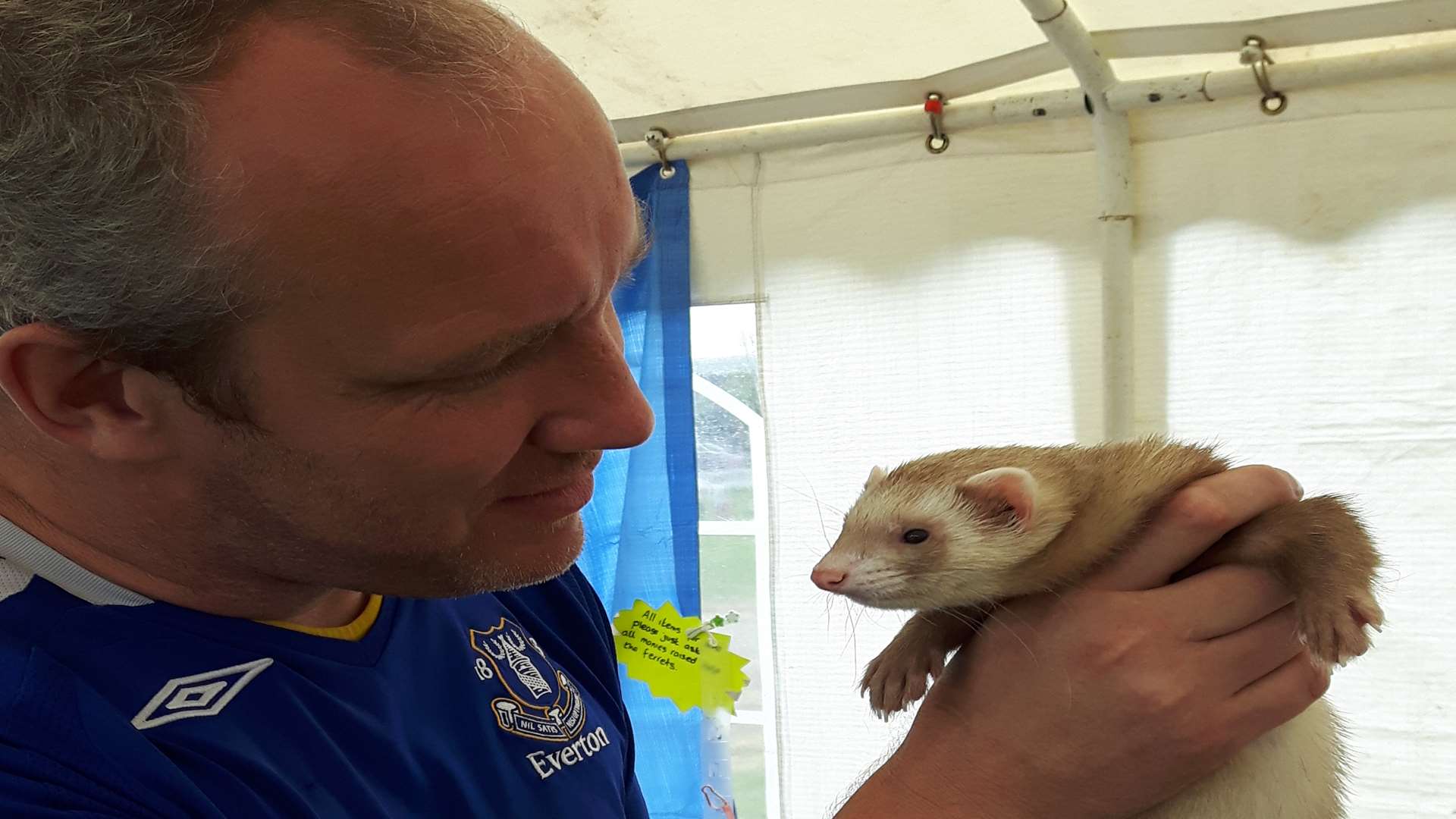 Barry Hadlow gets up close and personal to Pepper the ferret.