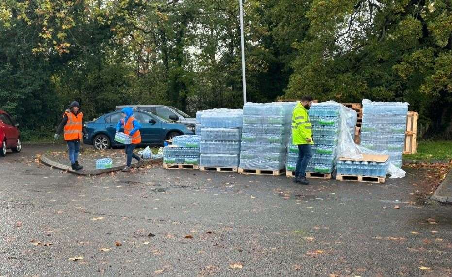 People helping at the water station in The Fowlers Car Park on Rye road in Hawkhurst . Picture: UKNIP
