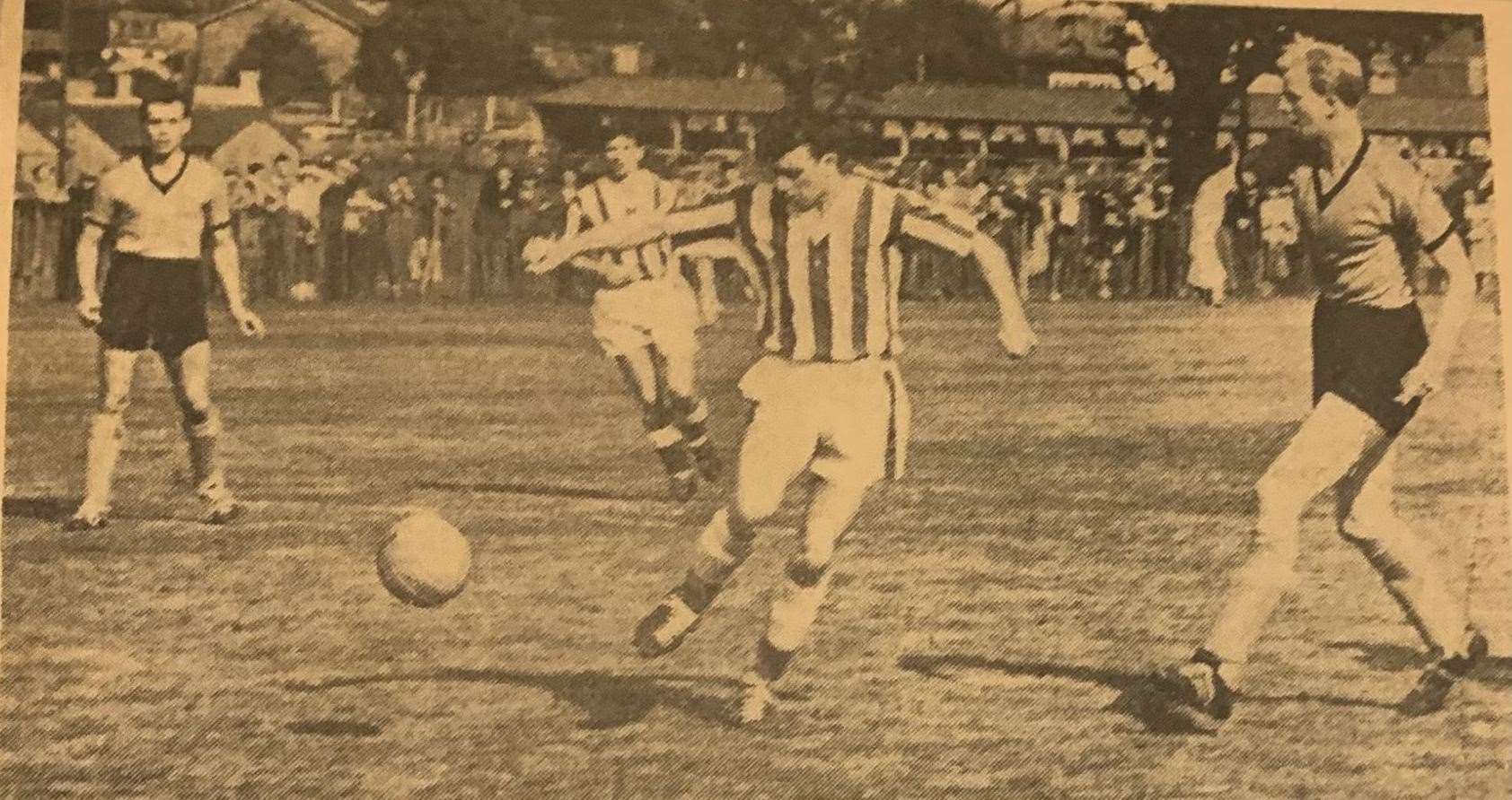 Tunbridge Wells United player Alan Back (in the striped jersey) in an attack on the Maidstone goal