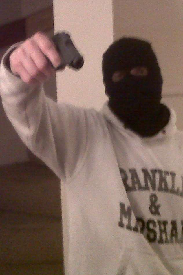 The self-taken photo showing one of the gang with a gun.