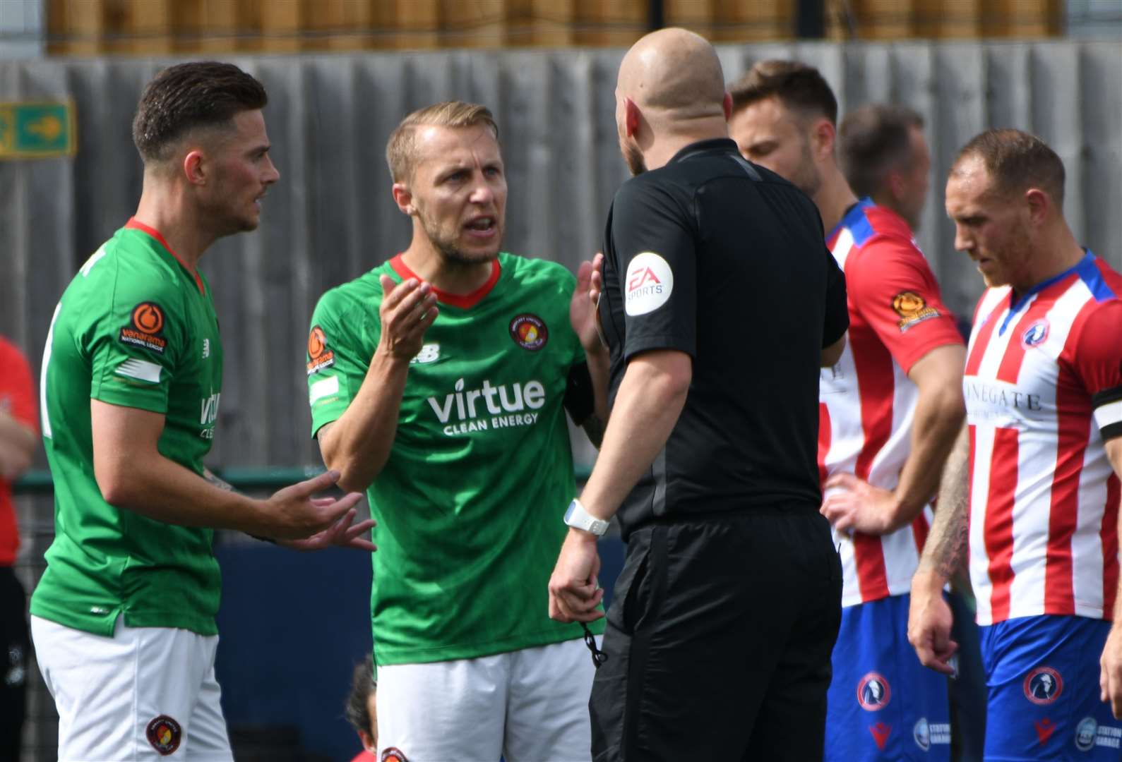 Fleet's Jack Paxman and Chris Solly make their point to referee Jason Richardson during the National League South play-off final against Dorking Wanderers. Picture: Barry Goodwin