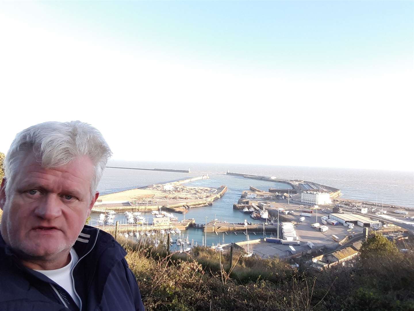 Sam Lennon has viewed drastic changes in Dover and its cross-Channel services. He is pictured in 2016 with the Western Docks and its former hoverport in the background.