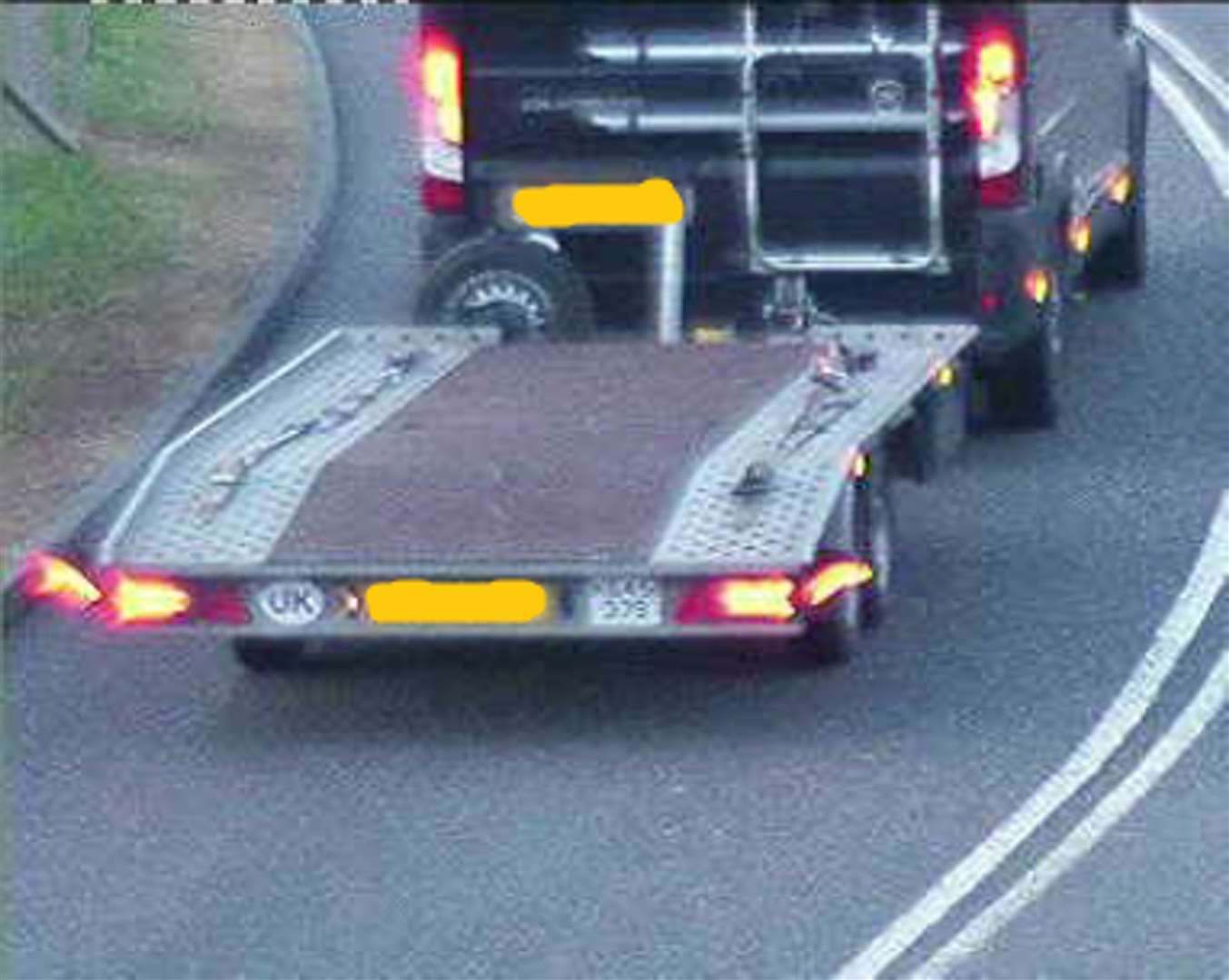 A specially adapted car pulling a trailer which had been converted to include a hide so drugs could be stored in it undetected (NWROCU)