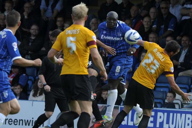 Adebayo Akinfenwa gets in a header against Bradford at Priestfield. Picture: Barry Goodwin