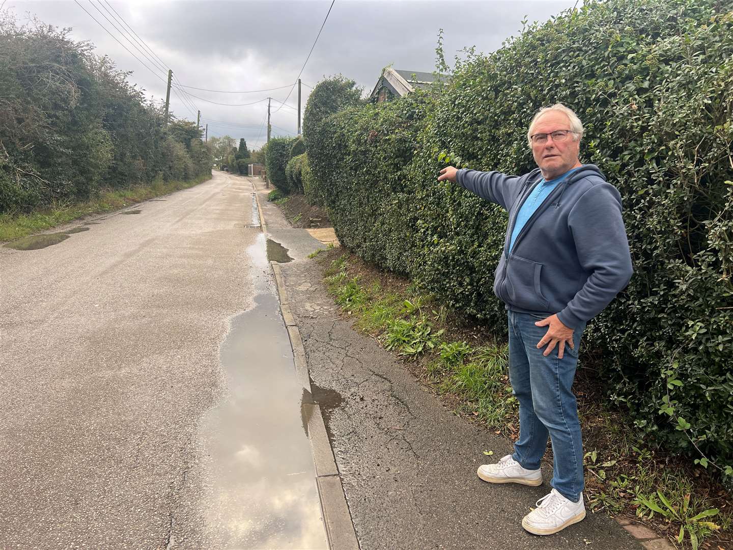Dennis Moyce pointing toward Warden Road. Picture: Megan Carr