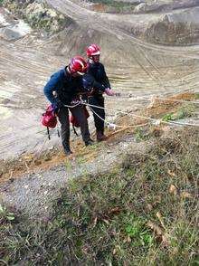 Rescuers are lowered to reach Dexter as he waits in the quarry