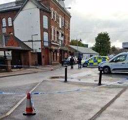 Two people have been charged after a man was stabbed outside Canterbury East railway station.