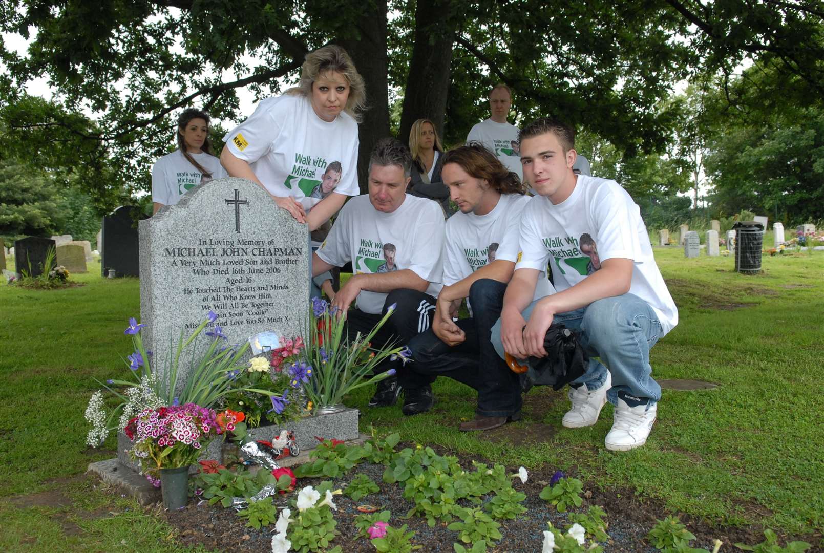 X-Factor star Ben Mills at Michael Chapman's graveside at Bobbing church before the dedication to a memorial bench with, from the left, Michael's mother and father Sue and Lloyd and his brother David. Picture: Mike Smith
