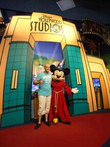 Andy Walker poses with Mickey Mouse in Disney World, Florida
