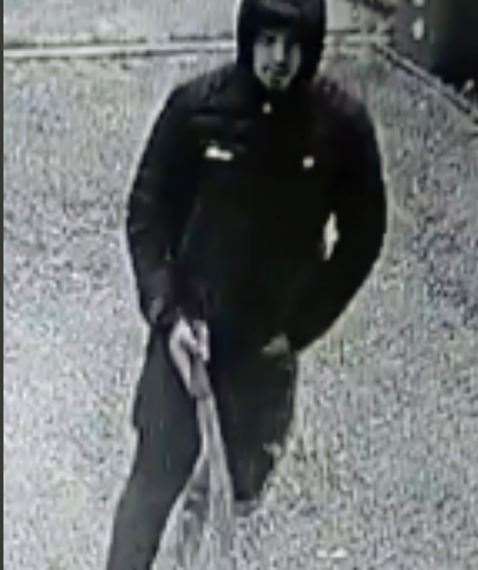 An image taken from CCTV footage shows Tyler Pomeroy brandishing a long blade