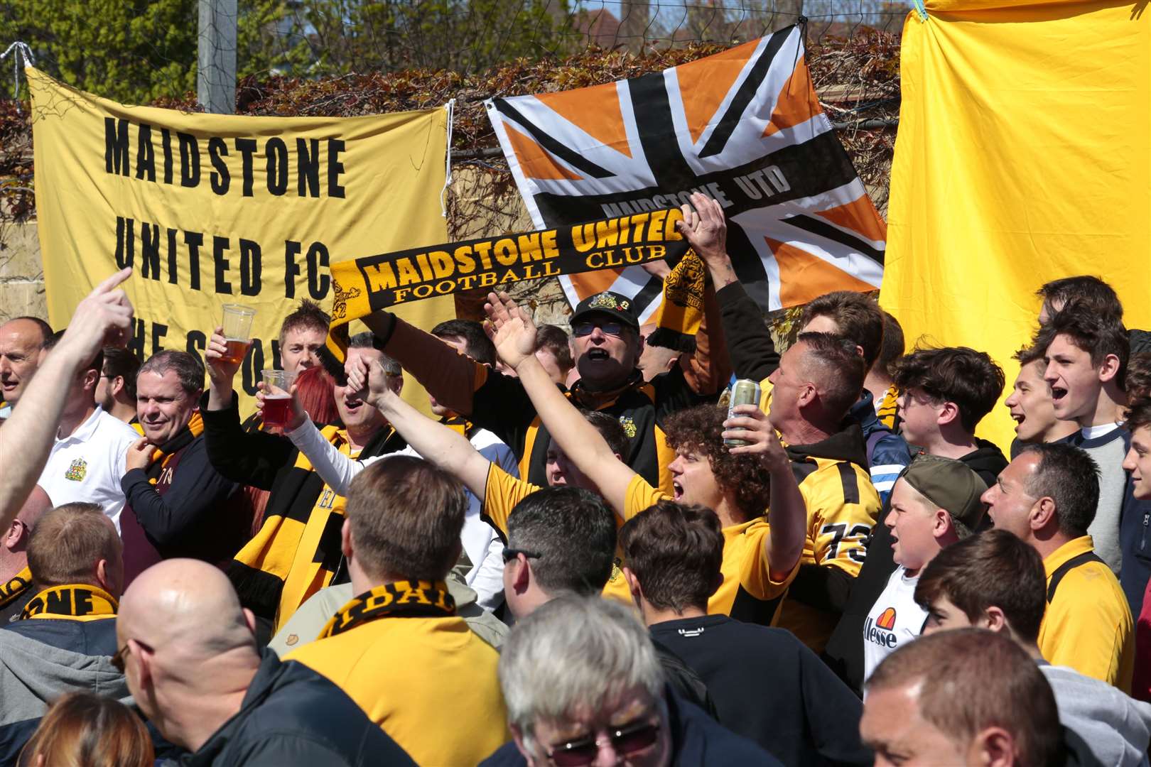 Maidstone United fans turn Champion Hill into a sea of black and amber