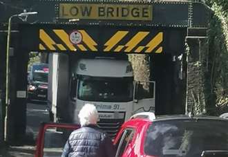 Lorry jammed under bridge