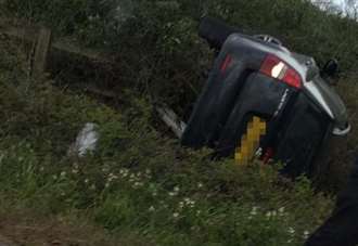 Delays on M2 as car overturns