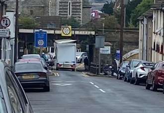 Road blocked as lorry hits bridge