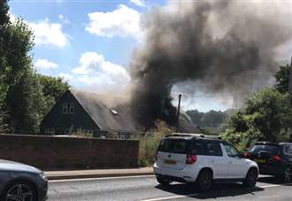 Road closed as crews tackle house fire