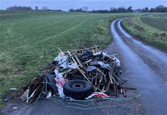 Building and roofing materials dumped along country lanes