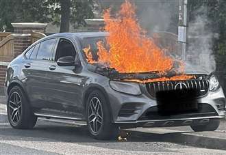 Mercedes goes up in flames in street