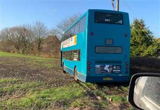 Double decker stuck after driver tried to turn around in field