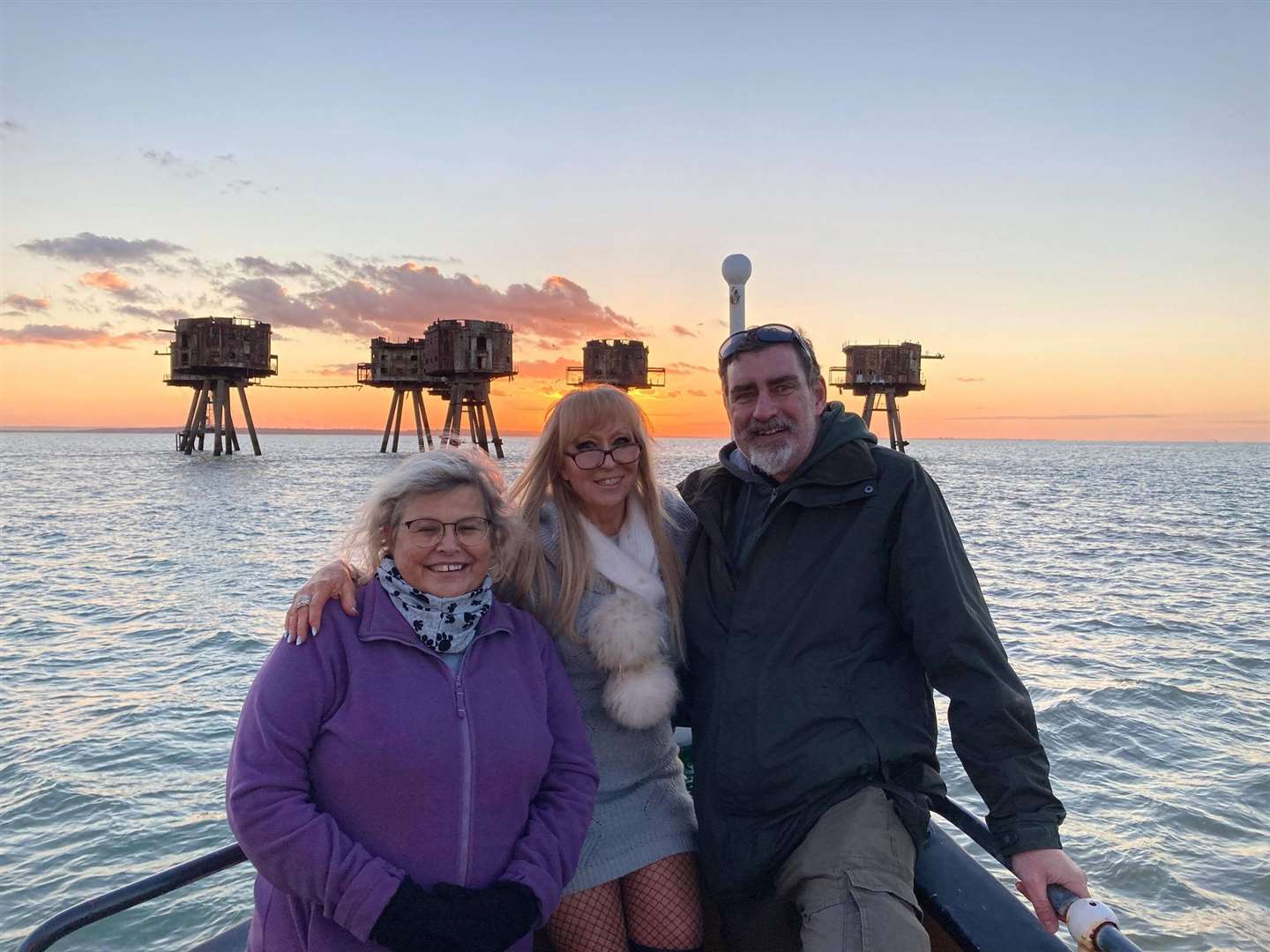 Clare and Andy Larkin with Margaret 'Flo' McEwan at the Second World War Maunsell sea forts at sunset courtesy of the X-Pilot launch based on Sheppey