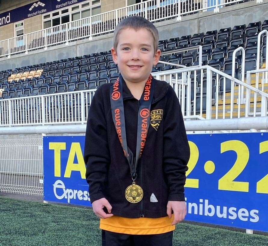 Joshua Wright with the National South medal given to him by former Maidstone manager Hakan Hayrettin.