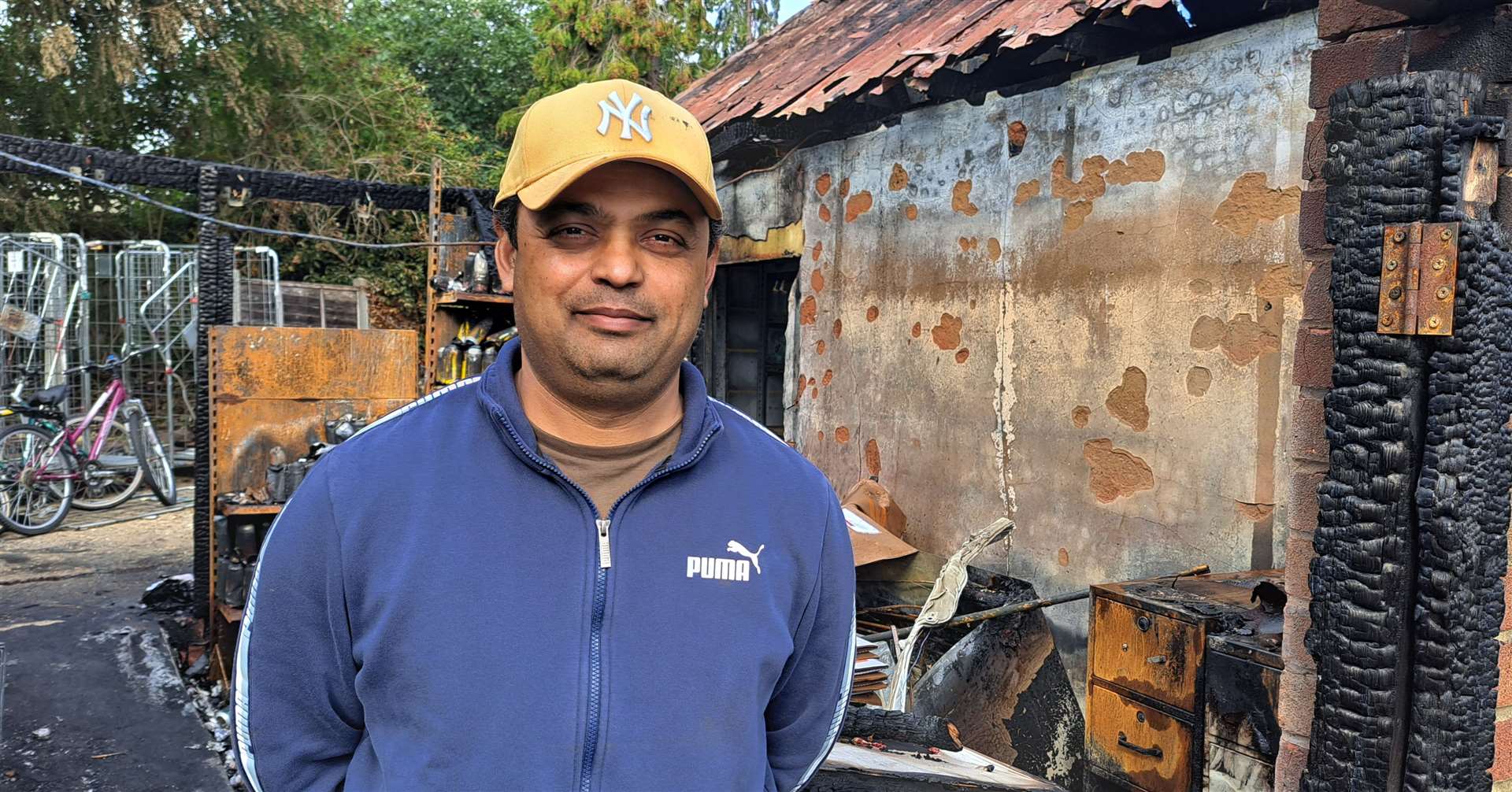Shopkeeper Jitendra Patel at the scene of the fire
