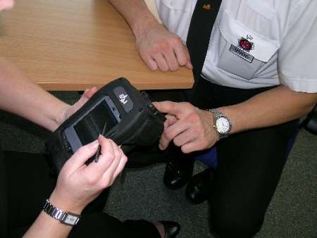 Police test the new mobile fingerprint equipment. Picture by Kent Police