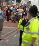 Police keep an eye on the protesters during Sunday's march. Picture: Barry Crayford