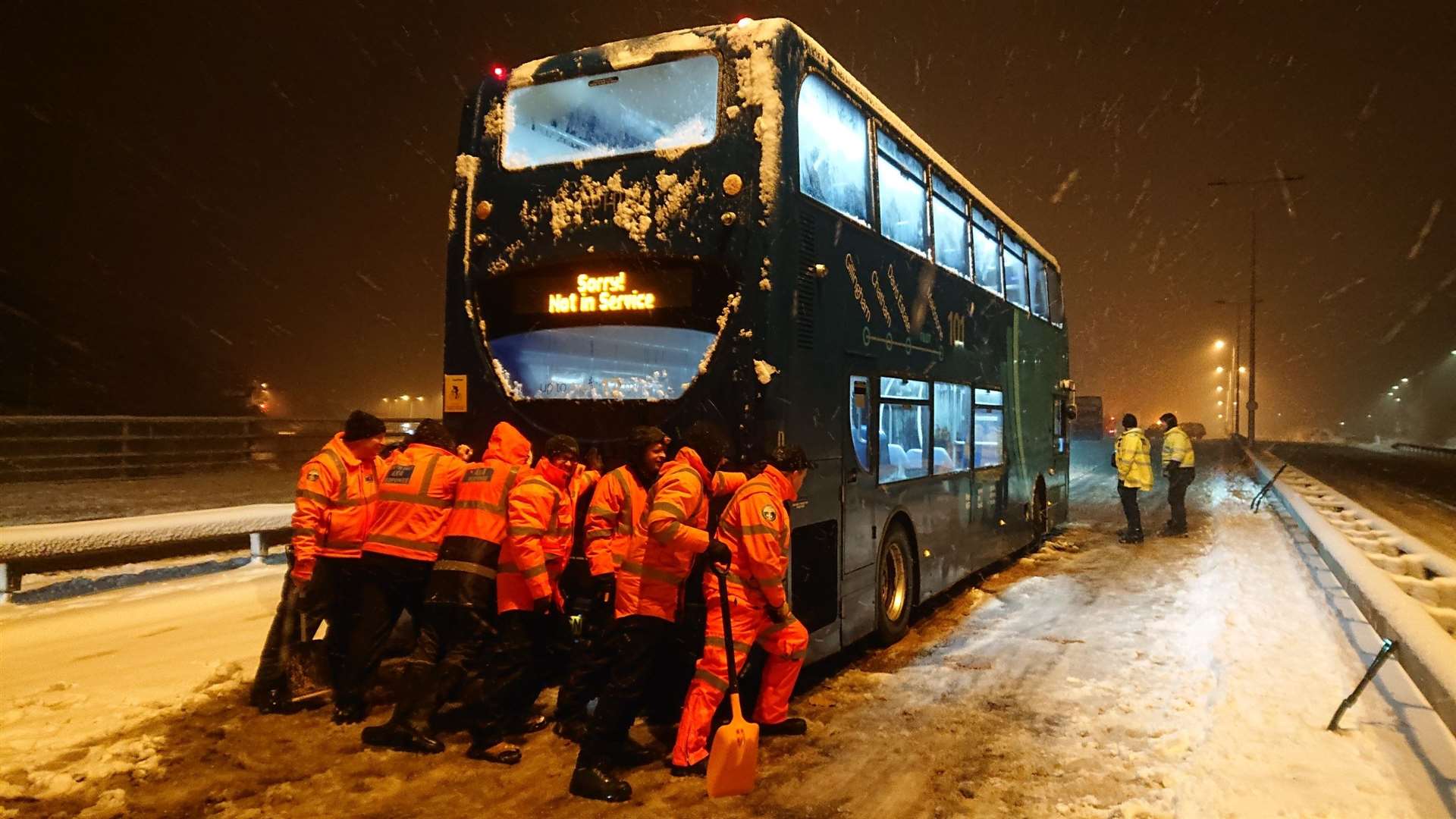 The team came together to shove a double decker bus out of the snow. Pic by Alan Moles