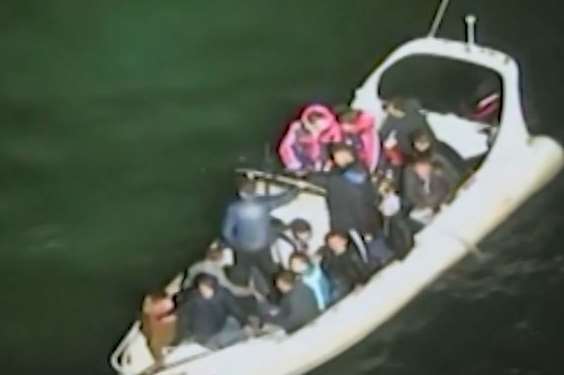 Footage from the coastguard helicopter shows passengers bailing water from the packed boat