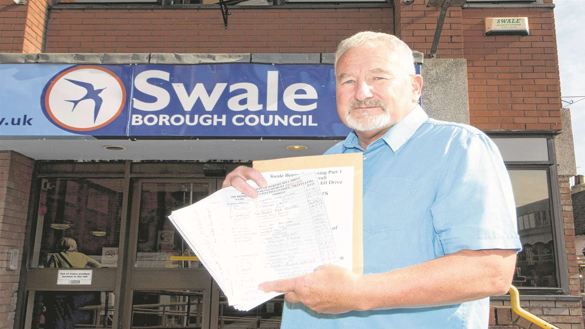 Minster resident Alan Bengall presenting a petition to Swale council at its offices in East Street, Sittingbourne over plans to build 500 new homes on Sheppey