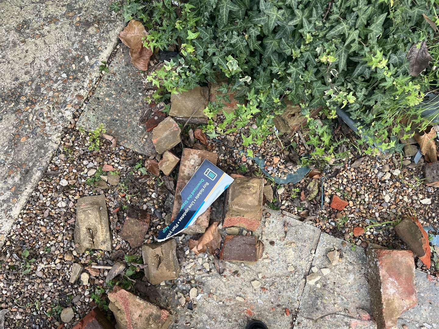 Bits from the bus stop have been left in the rubble in the house's front garden