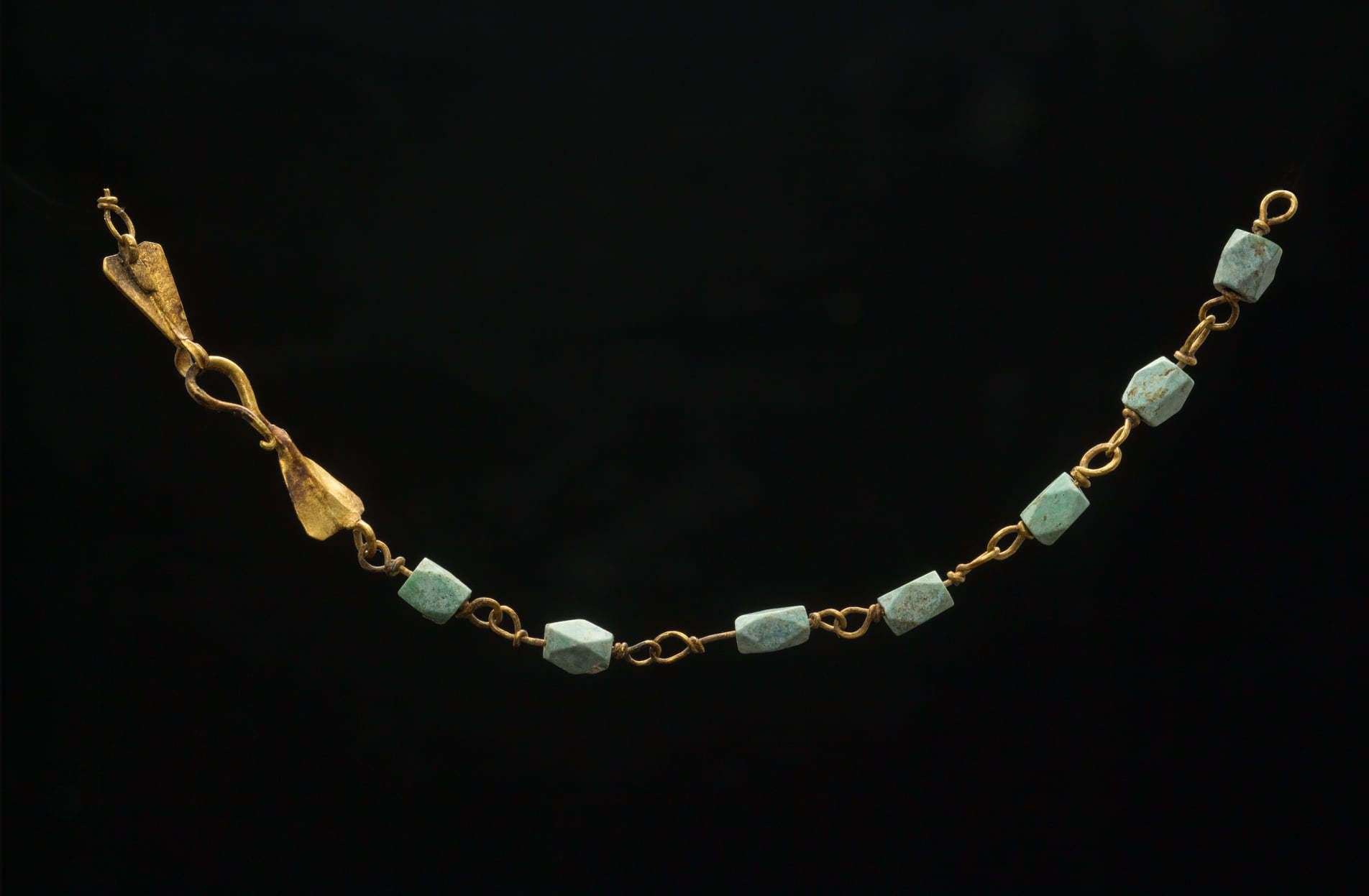 A gold filigree and variscite necklace from Grange Farm. Evidence suggests it could have been turned into a child's bracelet. Image from Pre-Construct Archaeology
