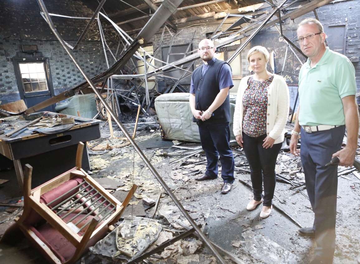 Father Peter, Lydia Birchall and Martin Sexton from St Francis Church assess the devastation