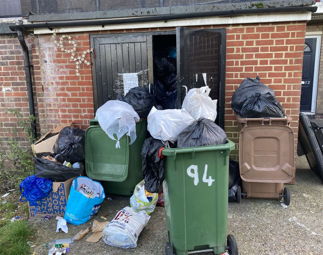 Bins have not been collected at the block of flats in Shakespeare Road, Temple Hill. Photo: Andy Newman