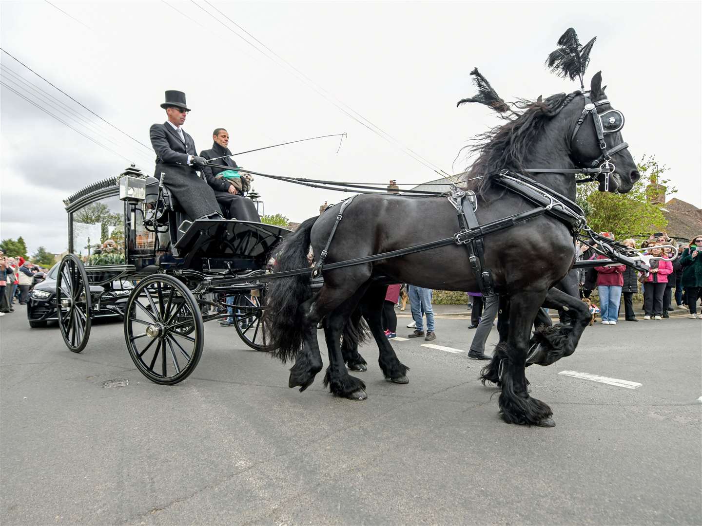 Paul O’Grady took his final journey through the village in a horse-drawn hearse. Picture: Stuart Brock