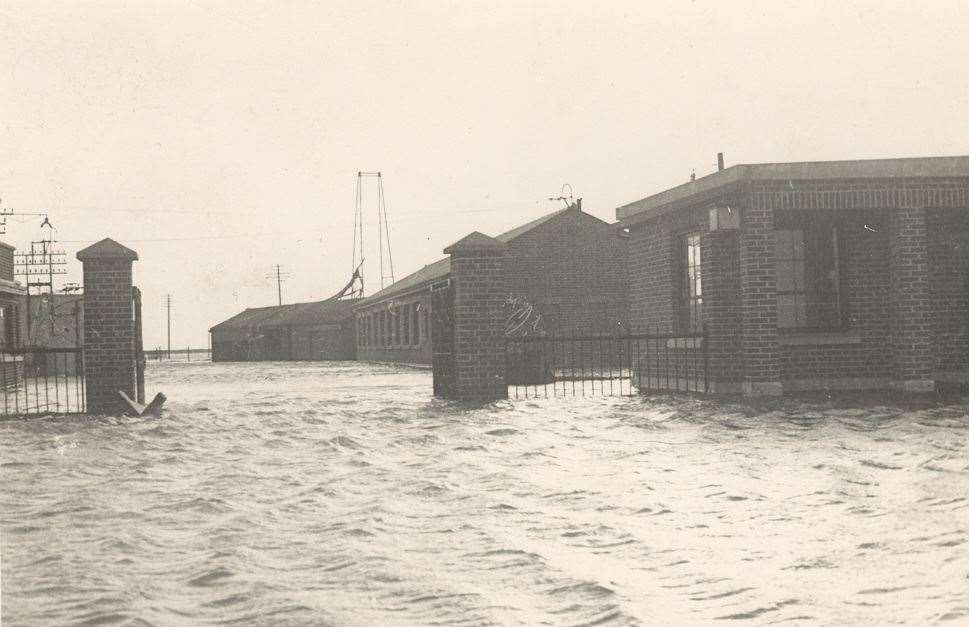 Flood waters wash through the grounds of the Medway Oil Storage Company on the Isle of Grain