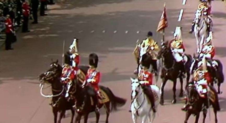 A still from the BBC coverage of the parade - the Queen's horse, bottom right, is startled by the gun shots as heads turn in the direction of where the shots were fired