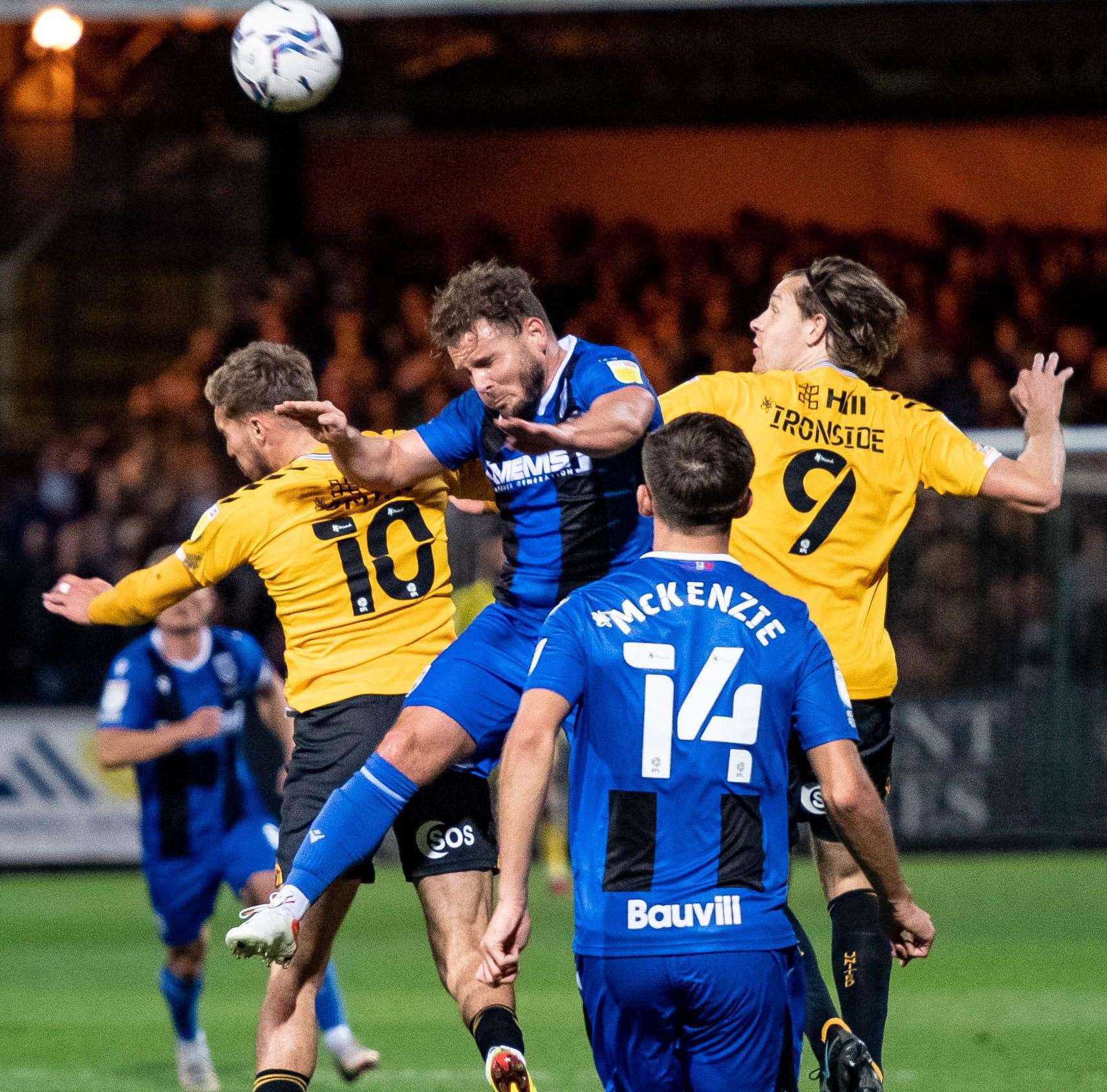 Gillingham challenge for the ball against Cambridge United Picture: Keith Heppell