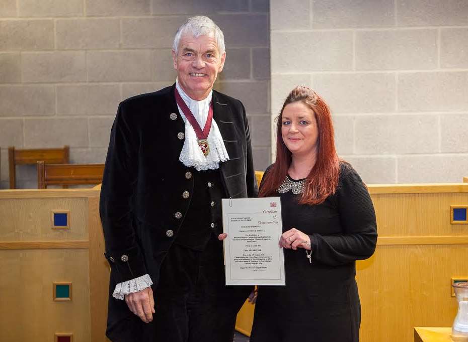 Clare Breakspear receives her award from High Sheriff William Alexander