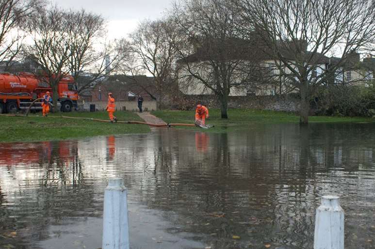 Workers begin to clear flood water in Faversham. Picture: Michael Maloney