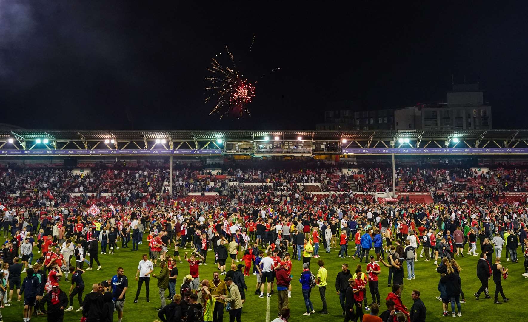 Nottingham Forest fans celebrate on the pitch after they reach the play off final (PA)