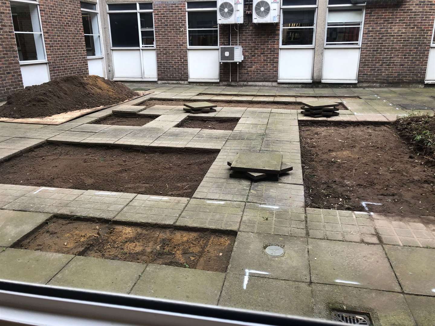 Tiles were removed before the flowerbeds and benches could be put in