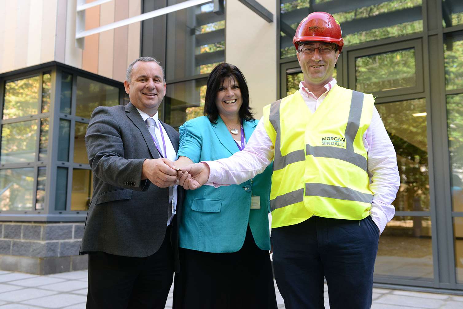 Morgan Sindall’s project manager Tony Black, right, hands over the keys to the new centre at East Kent College to director of curriculum Stewart Haywood and deputy principal Anne Leese